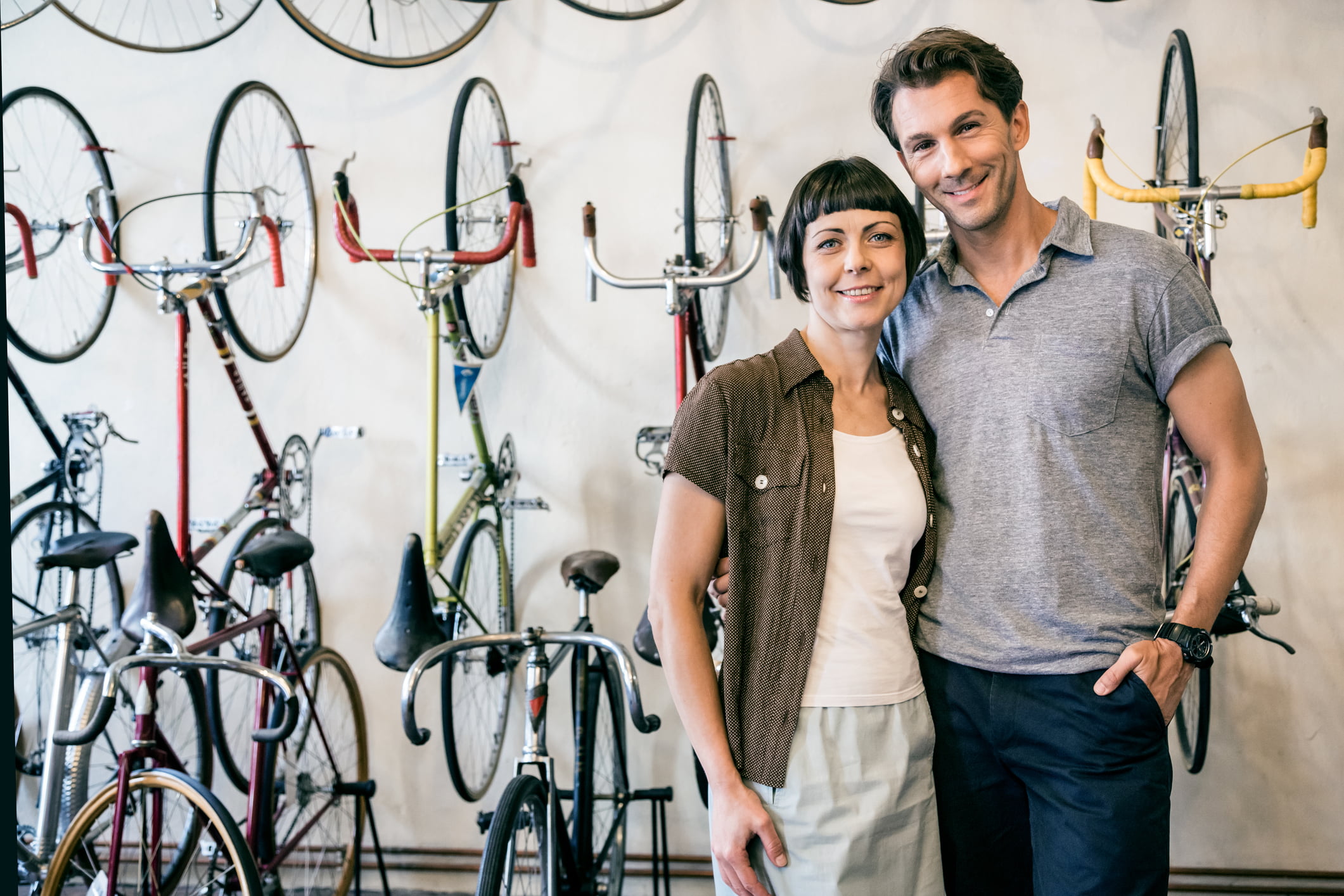 Mature couple and owner of a hip Berlin bike store. Some grain visible.
